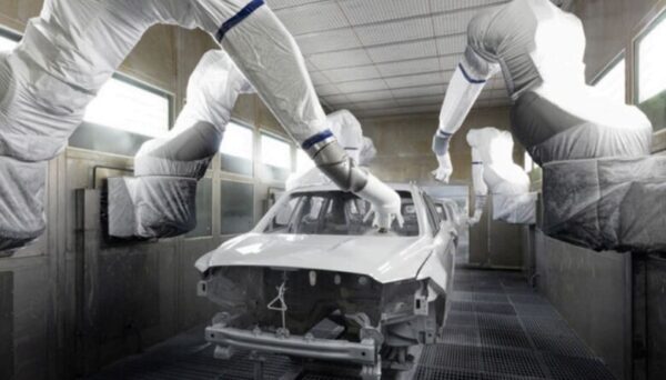 Robotic spray applicators coating a vehicle body on an automotive paint line