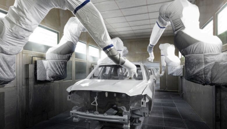 Robotic spray applicators coating a vehicle body on an automotive paint line